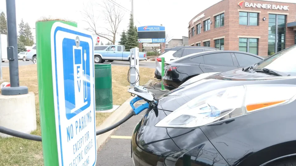 Industrial-grade NEMA 14-50 receptacle mounted in garage beside EV charging station in Spokane